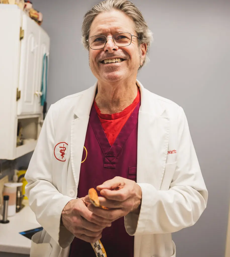 Dr. Schwartz treating a snake at Wheaton Animal Hospital